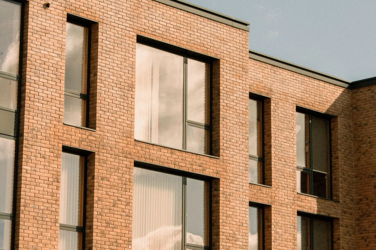 Modern low-rise brick apartment block, illustrative