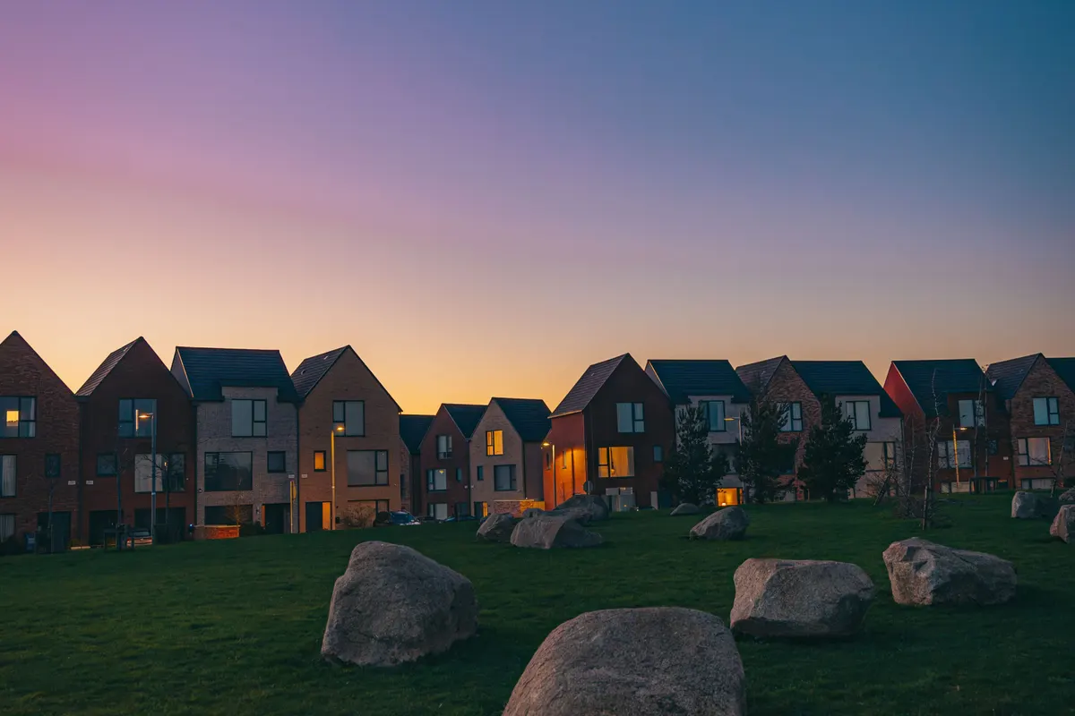 Row of new-build houses at dusk, illustrative